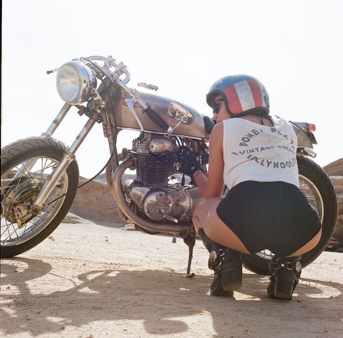 A playful frame from Girls on a motorcycle — online in Madrid